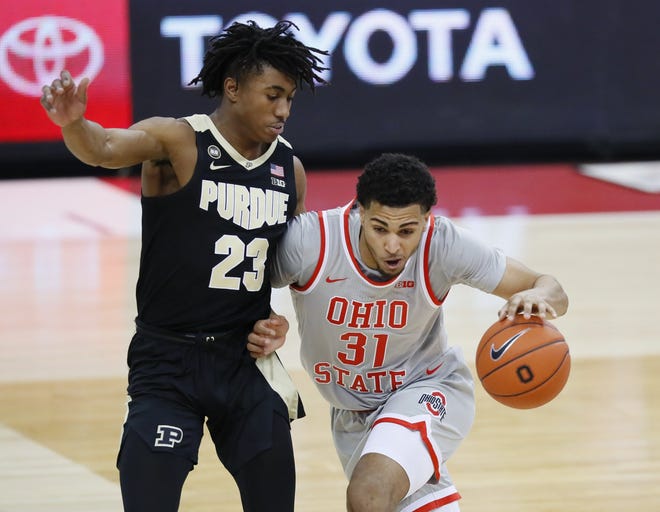 Ohio State's Seth Towns dribbles past Purdue's Jaden Ivey in Columbus on January 19, 2021.