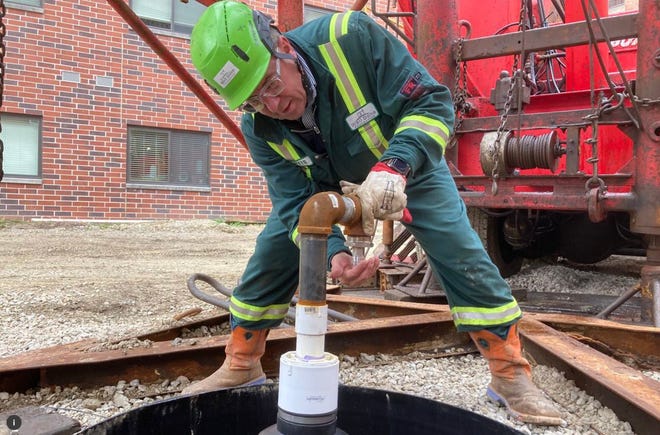 Curtis Shuck of the Well Done Foundation places a fitting in an old gas well pipe during preparations for plugging in Cleveland, Ohio last month.