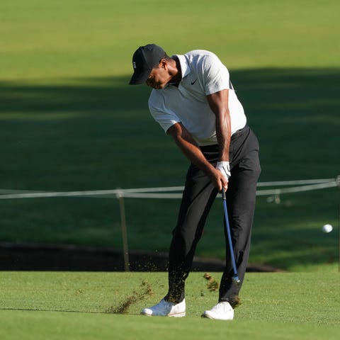 Tiger Woods hits from the fairway on the 10th hole