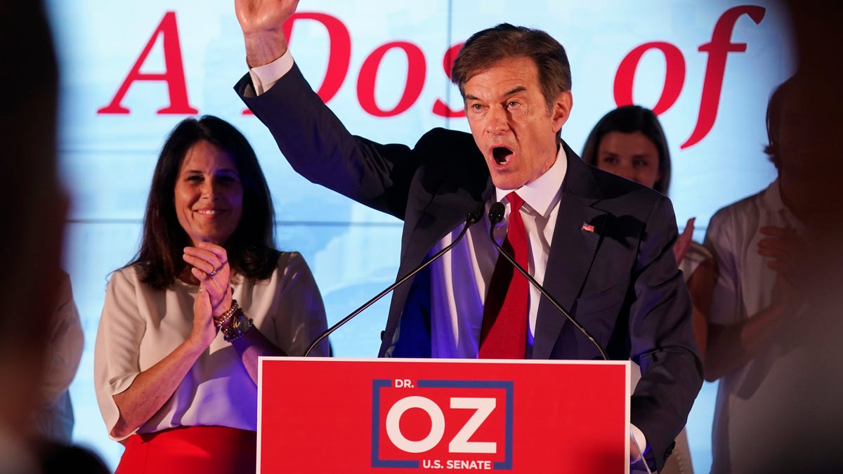 Mehmet Oz, a Republican candidate for U.S. Senate in Pennsylvania, right, waves in front of his wife, Lisa, while speaking at a primary night election gathering in Newtown, Pa., Tuesday, May 17, 2022. (AP Photo/Seth Wenig) ORG XMIT: PASW105