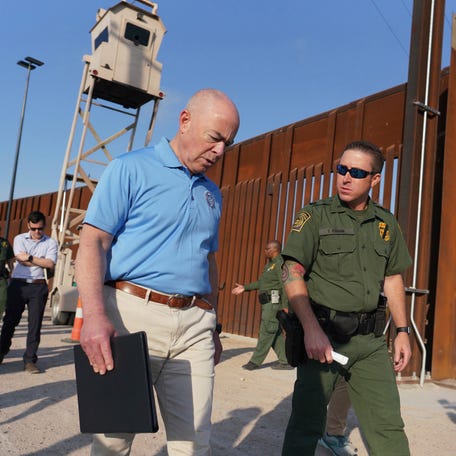 Homeland Security Secretary Alejandro Mayorkas, left, listens to Anthony Crane, deputy patrol agent in charge of the U.S. Border Patrol, as he tours the section of the border wall on May 17, 2022, in Hidalgo, Texas.
