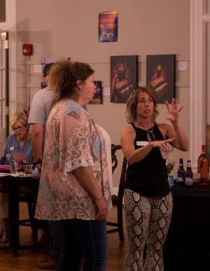 Paige Lamb and Pam Sapp discuss work on display at the Jefferson County Arts Guild's Spring Show.