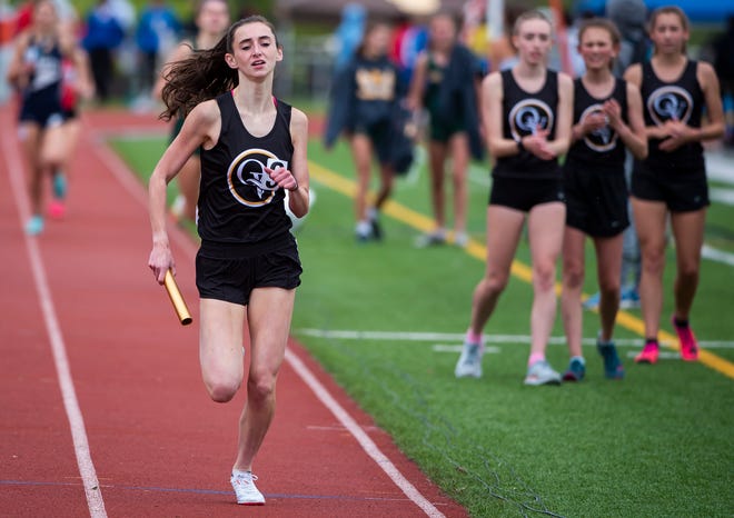 Quaker Valley's 4 x 800 relay members watch as teammate Ellie Cain pulls way ahead as the Quakers win gold at the WPIAL Track Individual Championships Wednesday, May 18 at Slippery Rock University.