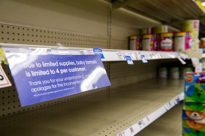 Empty shelves around a sign explaining to customers why they are limited to four baby formula products per visit at Kroger on Thursday, May 19, 2022.