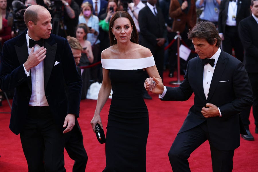 Prince William and Duchess Kate of Cambridge are escorted by Tom Cruise as they arrive for the UK premiere of the film "Top Gun: Maverick" in London, on May 19, 2022.