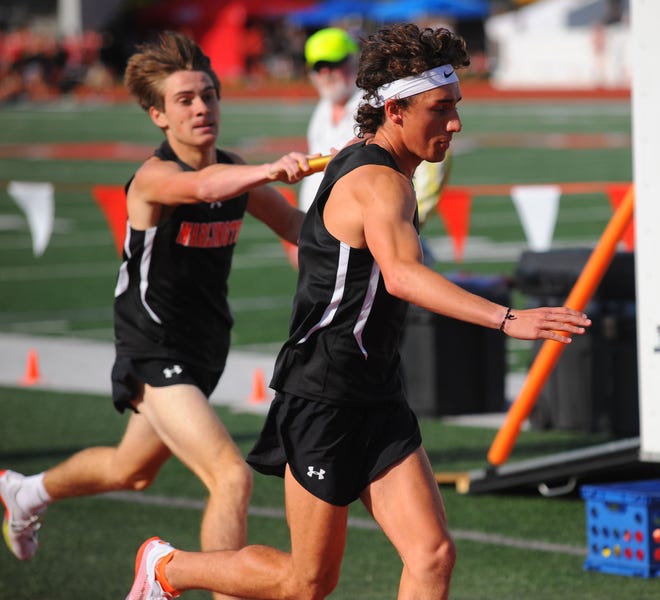 Marlington's Noah Graham receives the baton during the boys Division II 4x800 district final relay race at Sebo Stadium in Salem. The relay won the regional championship Thursday at Austintown Fitch.
