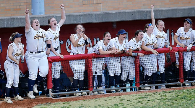 Hillsdale High School's dugout celebrates after Isabella Dalton's game winning RBI base hit in the sixth inning during their OHSAA Division IV District Championship game Thursday, May 19, 2022 at Akron Firestone Stadium. Hillsdale won the game 6-3. TOM E. PUSKAR/TIMES-GAZETTE.COM