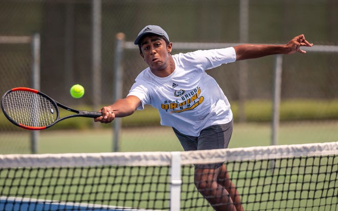 Rock Bridge's Akhilan Elangovan stretches for a return during the Class 3 boys doubles tennis championship Friday at Cooper Tennis Complex in Springfield.