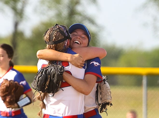 Tuslaw seniors Macaira Fox (right) and Meridith Rankl (left) are all smiles as they hug after earning back-to-back District Championships in Div. III with an 11-1 win over Norwayne.