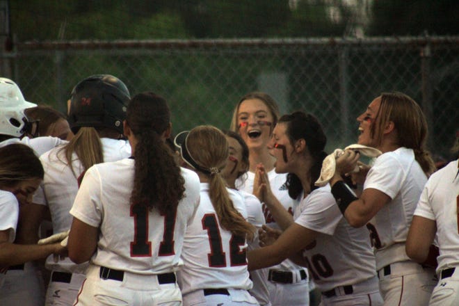 Baldwin players celebrate a go-ahead home run by Piper Young (24) against Keystone Heights in the Florida High School Athletic Association Region 1-3A softball final on May 19, 2022. [Clayton Freeman/Florida Times-Union]