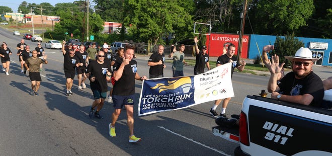Runners and police vehicles made their way east on West Franklin Boulevard early Friday morning, May 20, 2022, during the Law Enforcement Torch Run for Special Olympics of North Carolina.