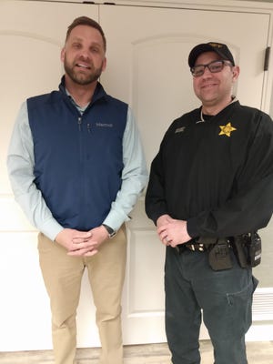 Deputy Nate Smith with the Brown County Sheriff’s Office, who teaches DARE classes in Frederick and Warner with Deputy Brandon Black, poses with of Seth Anderson of Pierson Ford and Lincoln, which donated money to the Brown County DARE program.