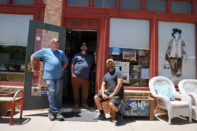 Rick Johnson, left, David Van Auker and Buck Burns, owners of Manzanita Ridge, a furniture and antique store in Silver City, New Mexico.
