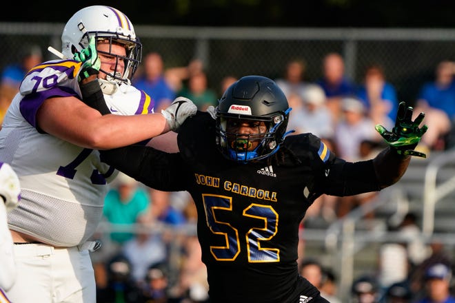 John Carroll Catholic’s defensive lineman Wilky Denaud (52) makes a tackle against Fort Pierce Central in a spring football game Thursday, May 19, 2022, in Fort Pierce. John Carroll Catholic won 34-7.