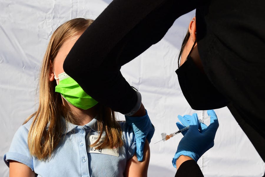 In this file photo taken on November 05, 2021 a child receives a dose of Pfizer's Covid-19 vaccine at an event launching school vaccinations in Los Angeles, California.