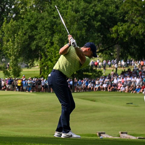 First-round leader Rory McIlroy plays a shot on th