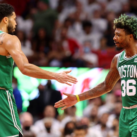 Jayson Tatum and Marcus Smart celebrate after a fi
