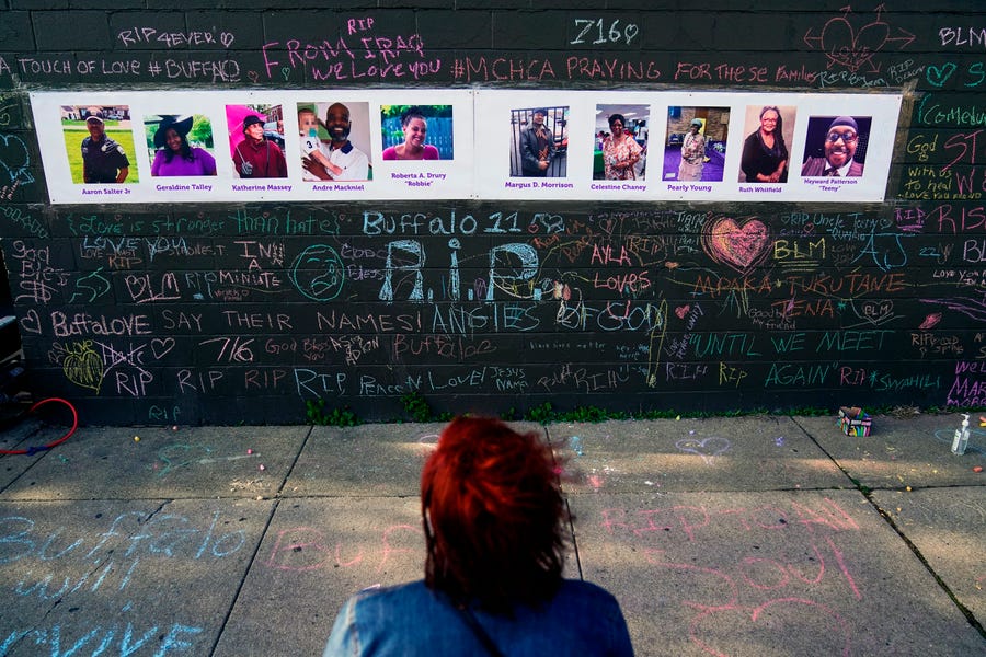 A makeshift memorial near the scene of a mass shooting at a supermarket in Buffalo, N.Y., honors the victims of an attack being investigated as a racist hate crime.