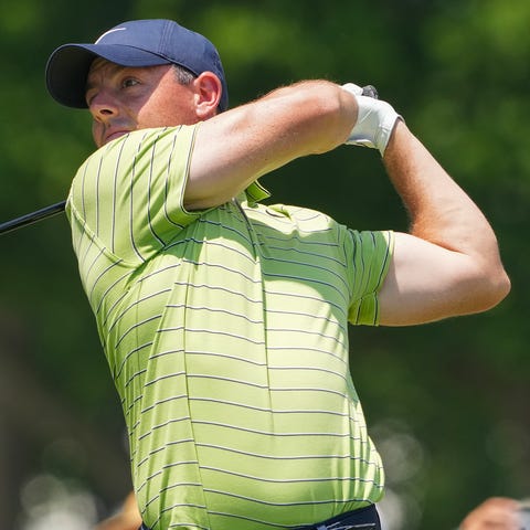 Rory McIlroy plays his shot on the ninth tee durin