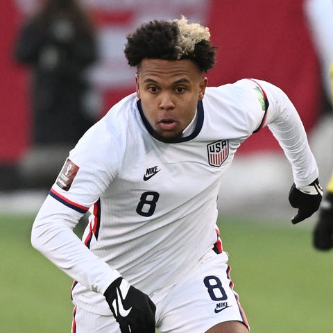 Weston McKennie, right, dribbles the ball away fro