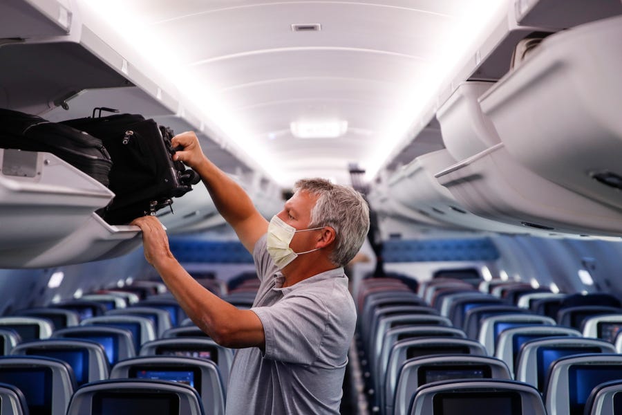 In this May 28, 2020, file photo, a passenger wears personal protective equipment on a Delta Airlines flight after landing in Minneapolis, United States of America.