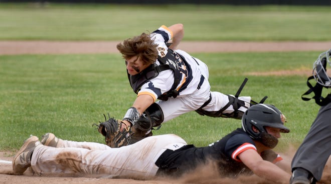 Summerfield's Jacob Wadsworth slides just under the tag by Whate catcher Luke Rasor Friday. Whiteford swept a doubleheader 9-3 and 10-0.