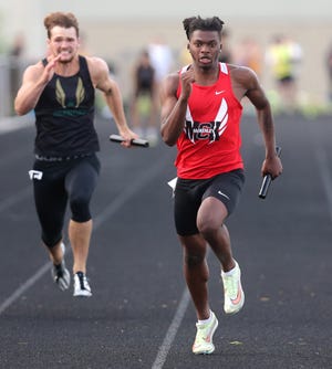 Caleb Ruffin (right) anchors McKinley's 400-meter relay team that won a Division I district title in May.