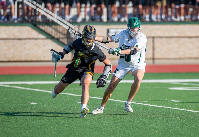 St. X Tigers' Trevor Havill (1) worked around the Trinity defense in the 2022 boys state lacrosse title game. The Tigers defeated the Shamrocks 13-6 for their fourth-straight title. May 20, 2022