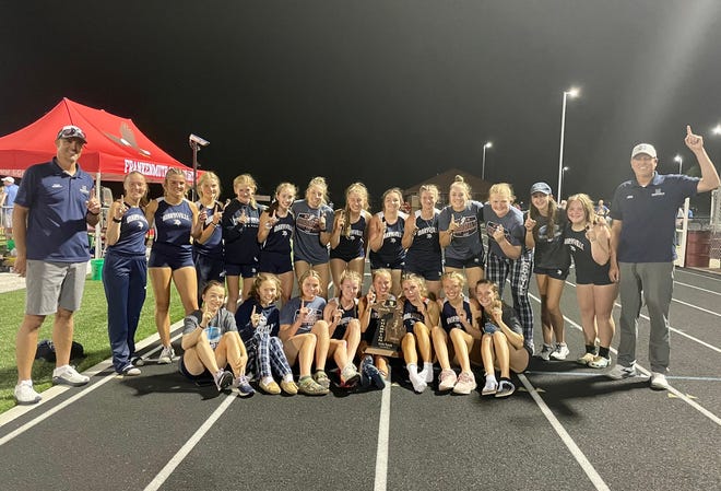 The Marysville girls track & field team celebrate after winning a Division 2 regional championship at Frankenmuth High School on Friday, May 20, 2022.