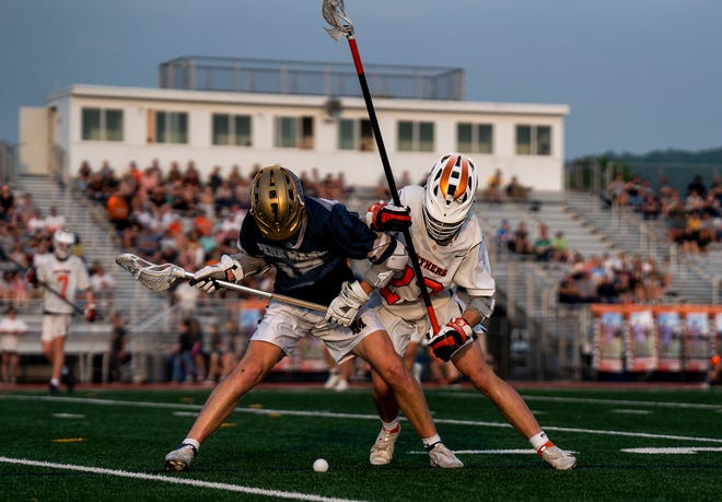 Penn Manor's Eli Warfel (18) and Central York's Ethan Wood (23) fighting for the ball in the Class 3-A boys lacrosse quaterfinal in Springettsbury on Friday, May 20, 2022.