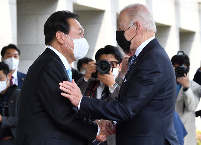 South Korean President Yoon Suk Yeol, left, greets President Joe Biden prior to their summit at the People's House in Seoul on Saturday, May 21, 2022.