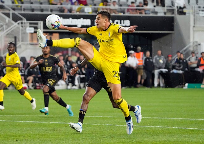 May 21, 2022; Columbus, Ohio, USA; Columbus Crew forward Miguel Berry (27) tries to bring down the ball against Los Angeles FC defender Sebastien Ibeagha (25) in the rain during the 1st half of the MLS game between the Columbus Crew and Los Angeles FC at Lower.com Field in Columbus, Ohio on May 21, 2022.