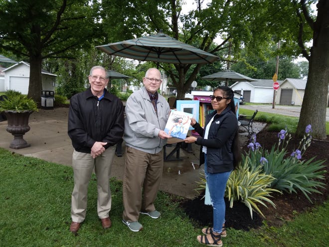 Mark Atleson (left), Rabbi Emeritus John Spitzer and Ana Baca Gomez are shown in front of the Little Free Library installed behind Softies in Dover. Spitzer and Gomez are holding a copy of  "Justice Is...: A Guide for Young Truth Seekers,'' which was among the books placed inside the box.