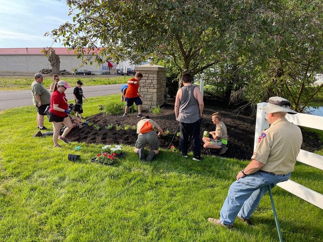 Boy Scouts from Troop 21 of Pataskala recently planted flowers at both entrances to the Orchard Glen subdivision in Etna.