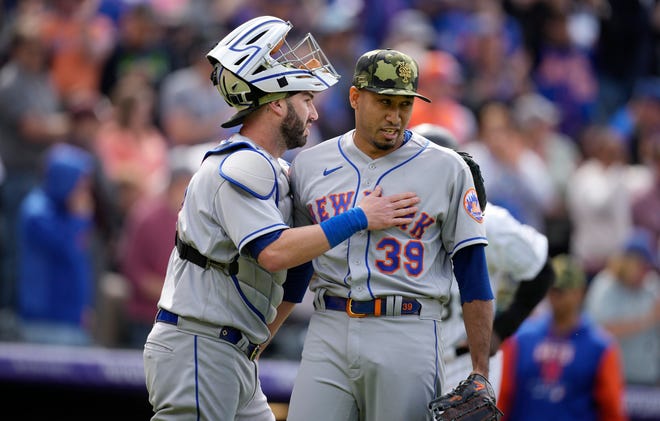New York Mets catcher Tomas Nido, left, congratulates relief pitcher Edwin Diaz after Diaz retired Colorado Rockies' Brian Serven for the final out in the ninth inning of a baseball game Sunday, May 22, 2022, in Denver.