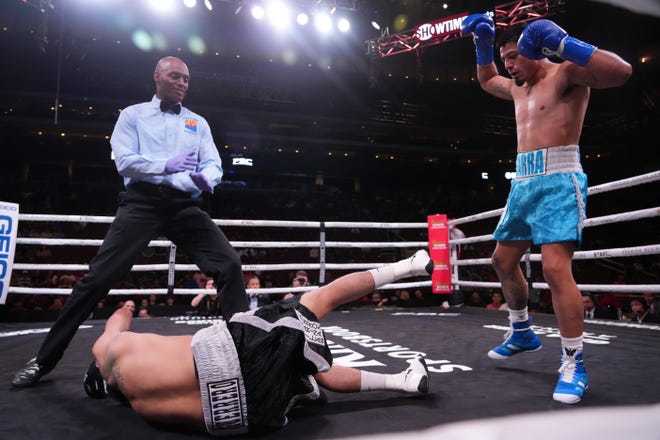Jesus Abel Ibarra (blue trunks) knocks out Ernesto Guerrero (black trunks) during a Premier Boxing Champions card at Gila River Arena.
