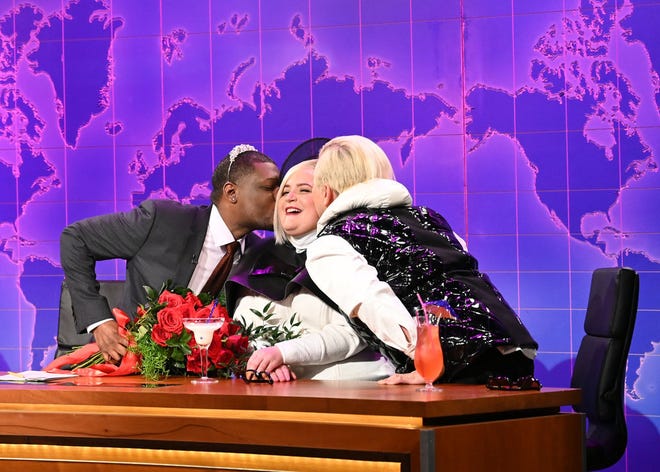 "Weekend Update" anchor Michael Che (left) and Bowen Yang (right) send off cast member/trend forecaster Aidy Bryant with a smooch on the cheek after 10 years "in."