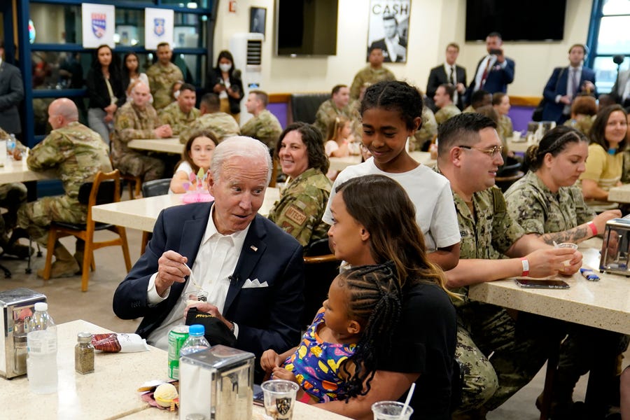 May 22, 2022:  President Joe Biden, center left, talks with the family of an American service member at Osan Air Base in Pyeongtaek, South Korea.