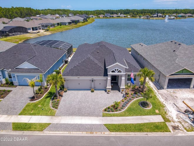 A paver driveway leads to this 2020 Adley-built lakefront home in the desirable Daytona Beach community of Mosaic.