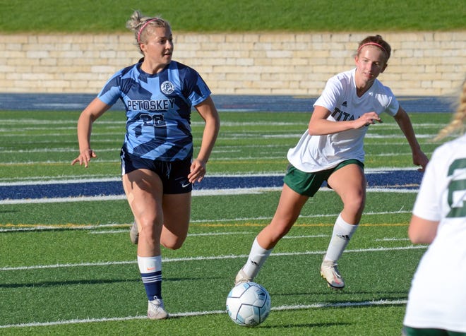 Petoskey senior Emma Nicholson works the ball through a collection of Traverse City West defenders during the first half of the regular season finale Monday.