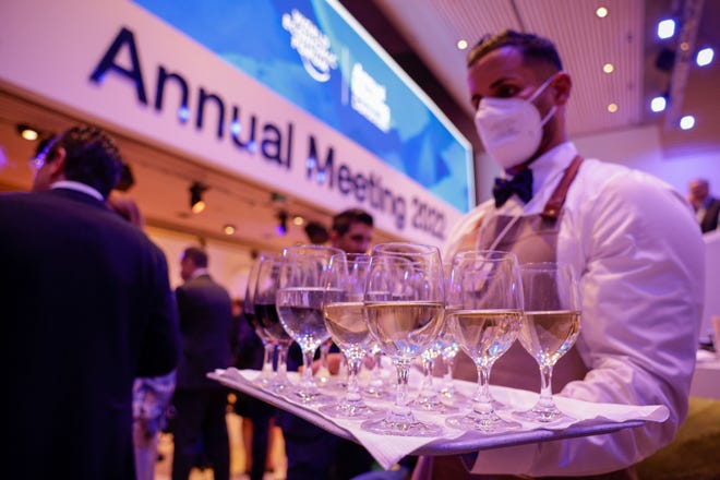 A waiter serves wine during the Welcome Reception ahead of the World Economic Forum (WEF) in Davos, Switzerland, on May 22, 2022. MUST CREDIT: Bloomberg photo by Jason Alden