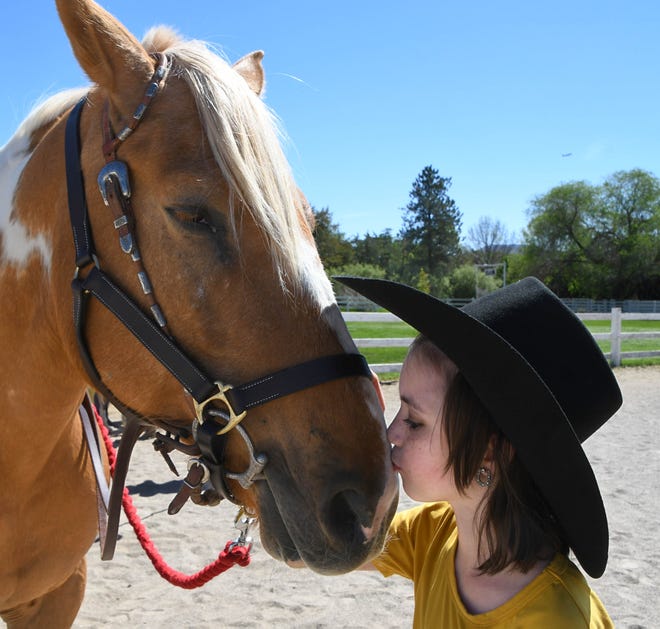Maliya Gafford, 10, of Dayton, Nev., kisses Boomerang, a horse she is about to ride Saturday May 21, 2022 at the Shadowood Farm in south Reno.