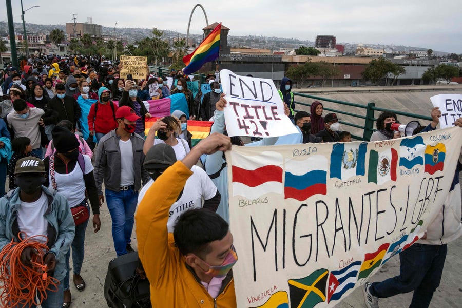 Migrants and asylum seekers march as they protest against Title 42 near the US-Mexico border in Tijuana, Baja California state, Mexico, on May 22, 2022.
