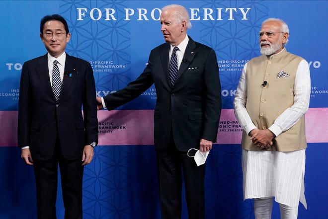 Japanese Prime Minister Fumio Kishida, left, President Joe Biden and Indian Prime Minister Narendra Modi pose for photos as they arrive at the Indo-Pacific Economic Framework for Prosperity launch event at the Izumi Garden Gallery, Monday, May 23, 2022, in Tokyo.