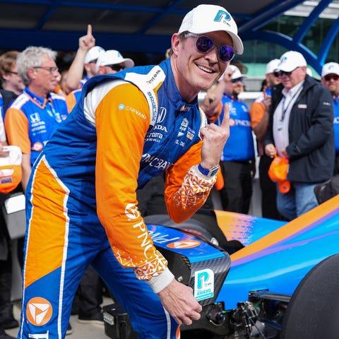 Scott Dixon celebrates after winning the pole for 