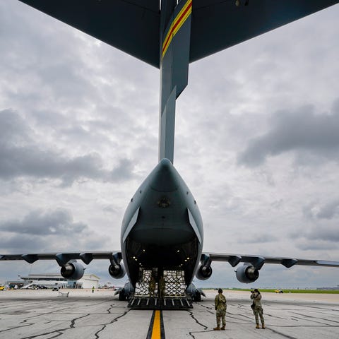 The crew of an Air Force C-17 begins to unload 132