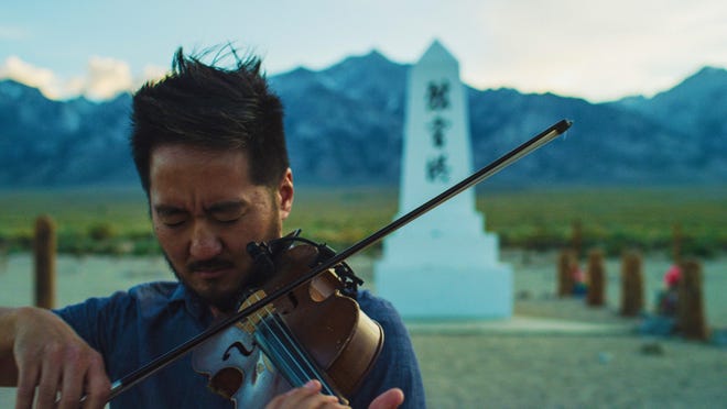 Kishi Bashi plays violin in front of a memorial at the Manzanar detention camp in California where Japanese Americans were held during WWII. The artist also known as Kaoru Ishibashi has made an album and a documentary about Japanese internment during the war.