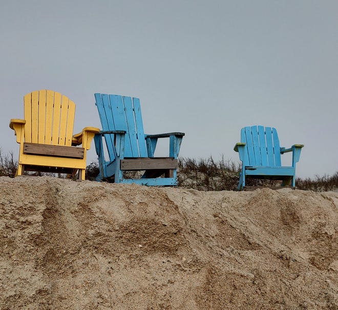 Chairs on top of beach sand cut at the end of 16th Street at St. Augustine Beach.