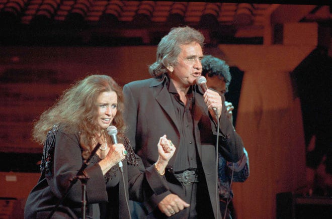 Johnny Cash and his wife, June Carter Cash, seen performing at Madison Square Garden in 1992. Their music and lives are the subject of Florida Studio Theatre’s production of “Ring of Fire.”
