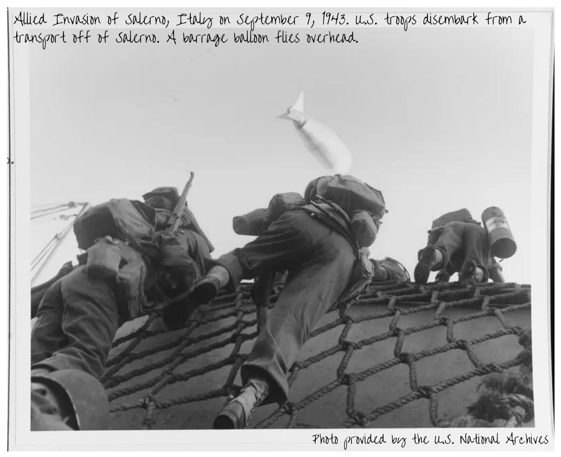 Allied Invasion of Salerno, Italy on September 9, 1943. U.S. troops disembark from a transport off of Salerno. Note barrage balloon overhead.